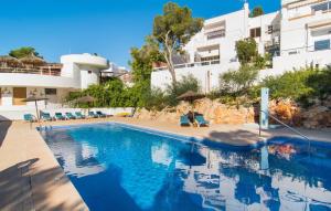 a swimming pool in front of a building at Playa D'or in Cala d´Or +33 photos