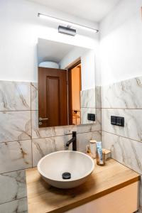 a bathroom with a sink and a mirror at The Forest Nest in Dealu Armanului +91 photos