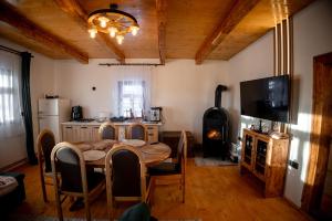a kitchen with a table and a wood stove at The Forest Nest in Dealu Armanului