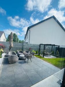 a patio with a group of chairs and an umbrella at Haven Stays - D15A5DF in Tyrrelstown