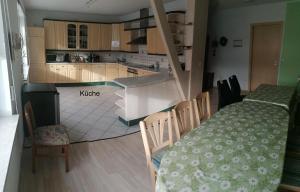 a kitchen and dining room with a table and a table and chairs at Gaestehaus Remde in Erfurt