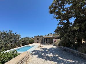 an exterior view of a house with a swimming pool at Calliste's House in Ioulis