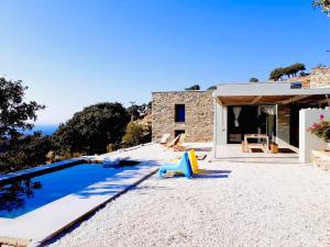 a villa with a swimming pool and a house at Calliste's House in Ioulis