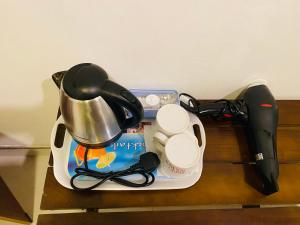 a coffee maker and a tea kettle on a table at Fairview Dill homestay in Sigiriya