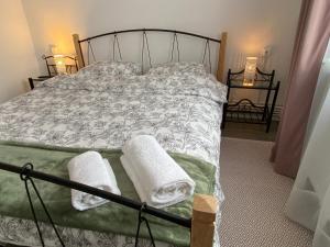 a bedroom with a bed with towels on it at Straja Nest in Lupeni