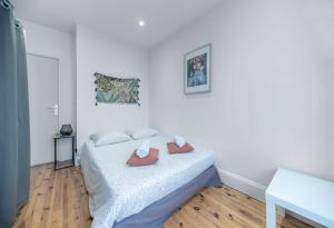 a bedroom with a bed with two slippers on it at Résidence Celestins - Appartements centre avec parking in Vichy +76 photos
