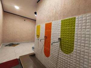 a bathroom with colorful tiles on the wall at Hotel Mawar Inn in Jenjarum +65 photos