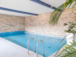 a swimming pool in a room with a brick wall at B&B Chalet Andy in Schenna +9 photos