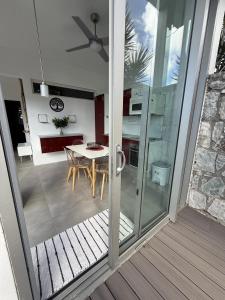 a kitchen and dining room with a sliding glass door at Stylish villa with private pool in Koolbaai in Koolbaai