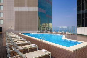 a swimming pool in a building with lounge chairs at JW Marriott Hotel Lima in Lima