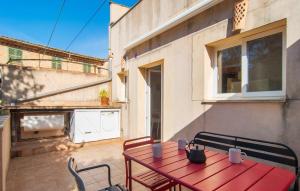 a red table and chairs on a patio at C'as Pobres in Sóller