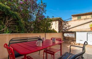 a red table and chairs on a patio at C'as Pobres in Sóller