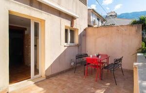 a red table and chairs on a patio at C'as Pobres in Sóller