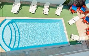 an overhead view of a swimming pool with lawn chairs at Awesome Apartment In Palmi in Palmi