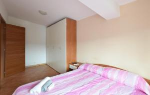 a bedroom with a bed with a pink bedspread at Awesome Apartment In Palmi in Palmi