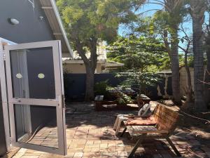 a patio with a chair and a glass door at Tolbos Backpackers in Worcester
