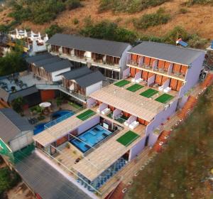an aerial view of a house with a swimming pool at Coco 7 Beach Resort in Mandrem