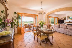 a living room with a table and a couch at Can Marines in S'Horta