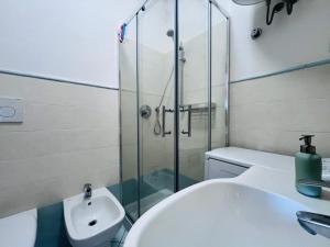 a bathroom with a sink and a glass shower at Capoliveri Lecce Home in Capoliveri