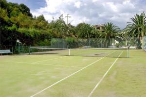 a tennis court with a net on top of it at Capoliveri Lecce Home in Capoliveri