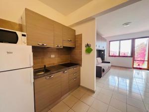 a kitchen with a sink and a refrigerator at Capoliveri Lecce Home in Capoliveri