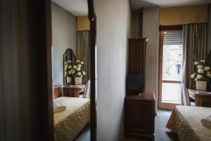 Posteľ alebo postele v izbe v ubytovaní Hotel Accursio