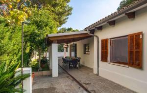 a patio of a house with a table and chairs at Es Baladre Beach in Alcudia