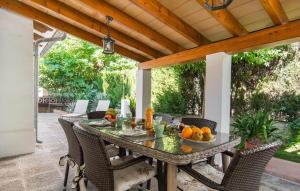 an outdoor table and chairs on a patio at Es Baladre Beach in Alcudia +34 photos