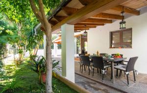 an outdoor dining room with a table and chairs at Es Baladre Beach in Alcudia