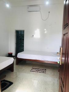 a bedroom with a large white bed in a room at Lumora Resort in Horuwila