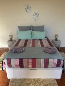 a bedroom with a bed with two towels on it at Casa Mary Bela's in Ponta do Sol