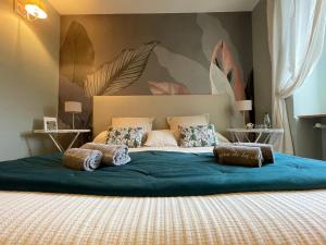 a bedroom with a large bed with blue sheets and pillows at Chambres d'hôtes du Domaine de la Manse in Villeneuve-de-Berg +38 photos