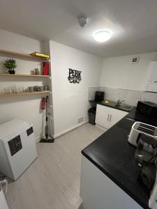a kitchen with a stove and a counter top at Horizon Hideaway in Swansea