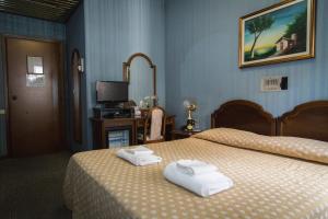Posteľ alebo postele v izbe v ubytovaní Hotel Accursio