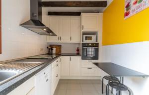 a kitchen with white cabinets and a black counter top at Duplex Can Roses in Moscari