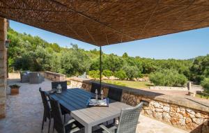 a wooden table and chairs under a wooden umbrella on a patio at Sa Finqueta in Manacor