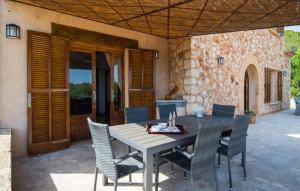 a wooden table and chairs on a patio at Sa Finqueta in Manacor