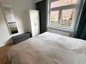 a bedroom with a large bed and a window at Kalkberg Ferienwohnungen in Bad Segeberg +77 photos