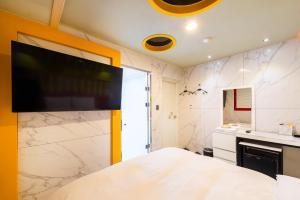 a bedroom with a large tv on the wall at Hotel Campanella in Seoul +32 photos