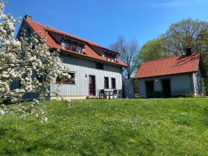 a house with a red roof and a green yard at Waldhaus am Lilienstein in Königstein an der Elbe