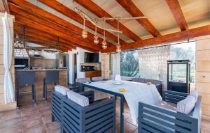 a kitchen and dining room with a table and chairs at Na Peixet in Artá