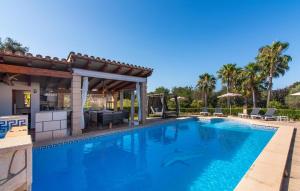 a swimming pool with a patio and a house at Na Peixet in Artá