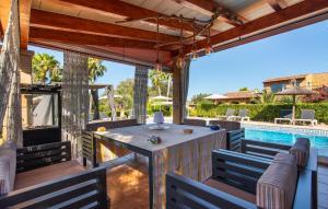 a patio with a table and chairs and a swimming pool at Na Peixet in Artá