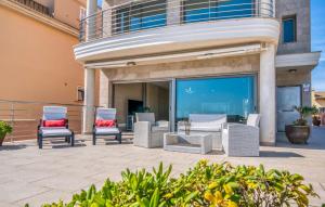 a group of chairs and tables on a patio at Bohemi in Son Serra de Marina