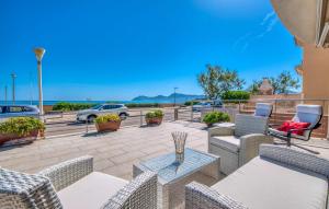 a patio with chairs and tables and a view of the ocean at Bohemi in Son Serra de Marina +49 photos