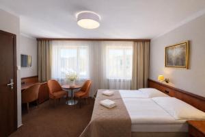 a hotel room with a bed and a table at Załęże in Katowice +25 photos