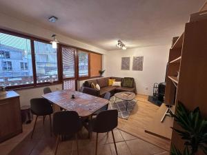 a living room with a table and a couch at Apartmán Donovaly 90 in Donovaly +10 photos