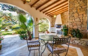 an outdoor patio with a table and chairs at Can Roca De Cala D'or in Cala d´Or +44 photos
