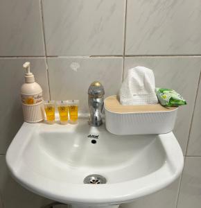 a white sink with a container on top of it at SAMA Economic Apartment in Medina