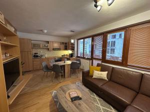 a living room with a couch and a table at Apartmán Donovaly 90 in Donovaly
